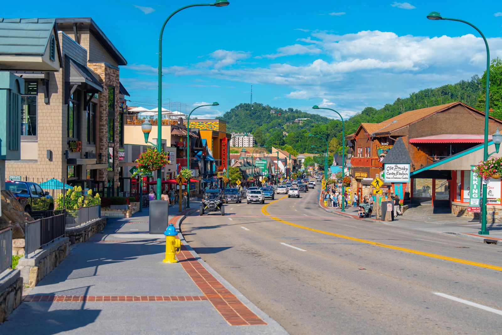 Vibrant street scene on a sunny day in Gatlinburg, showcasing shops and scenic views.
