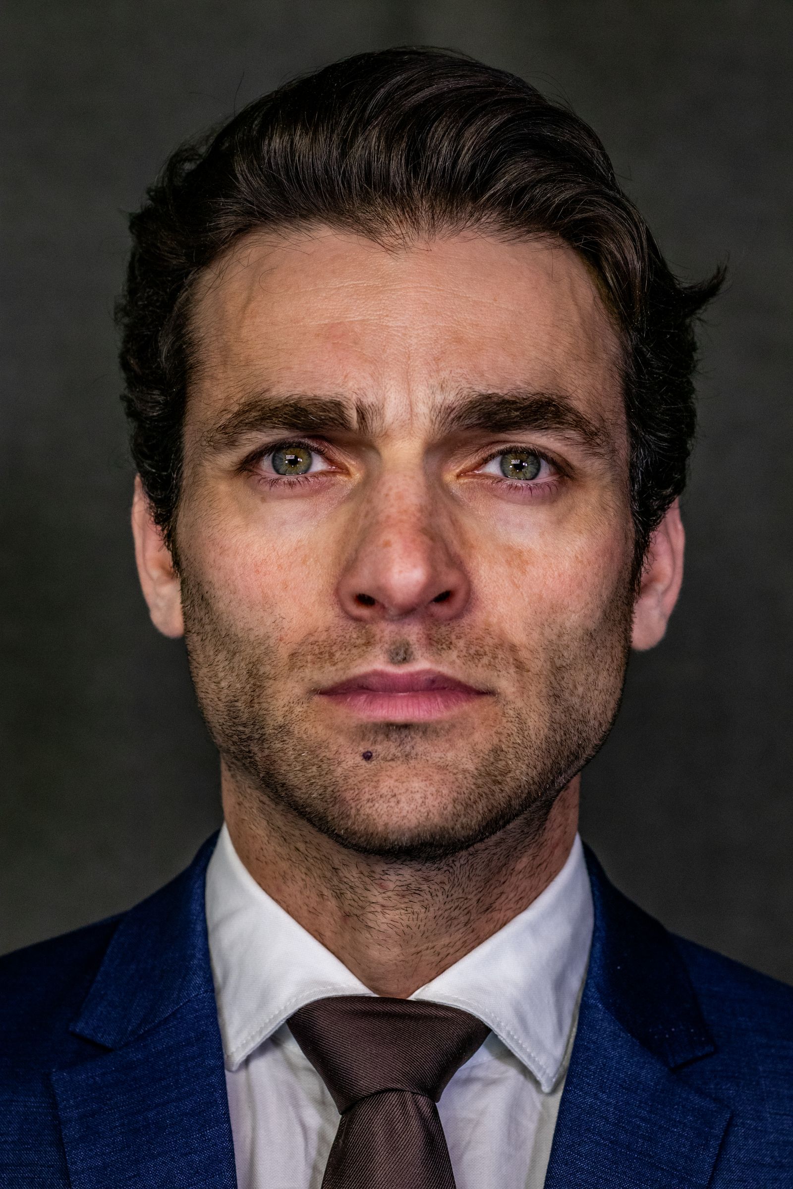 Close-up portrait of a serious businessman in formal attire.
