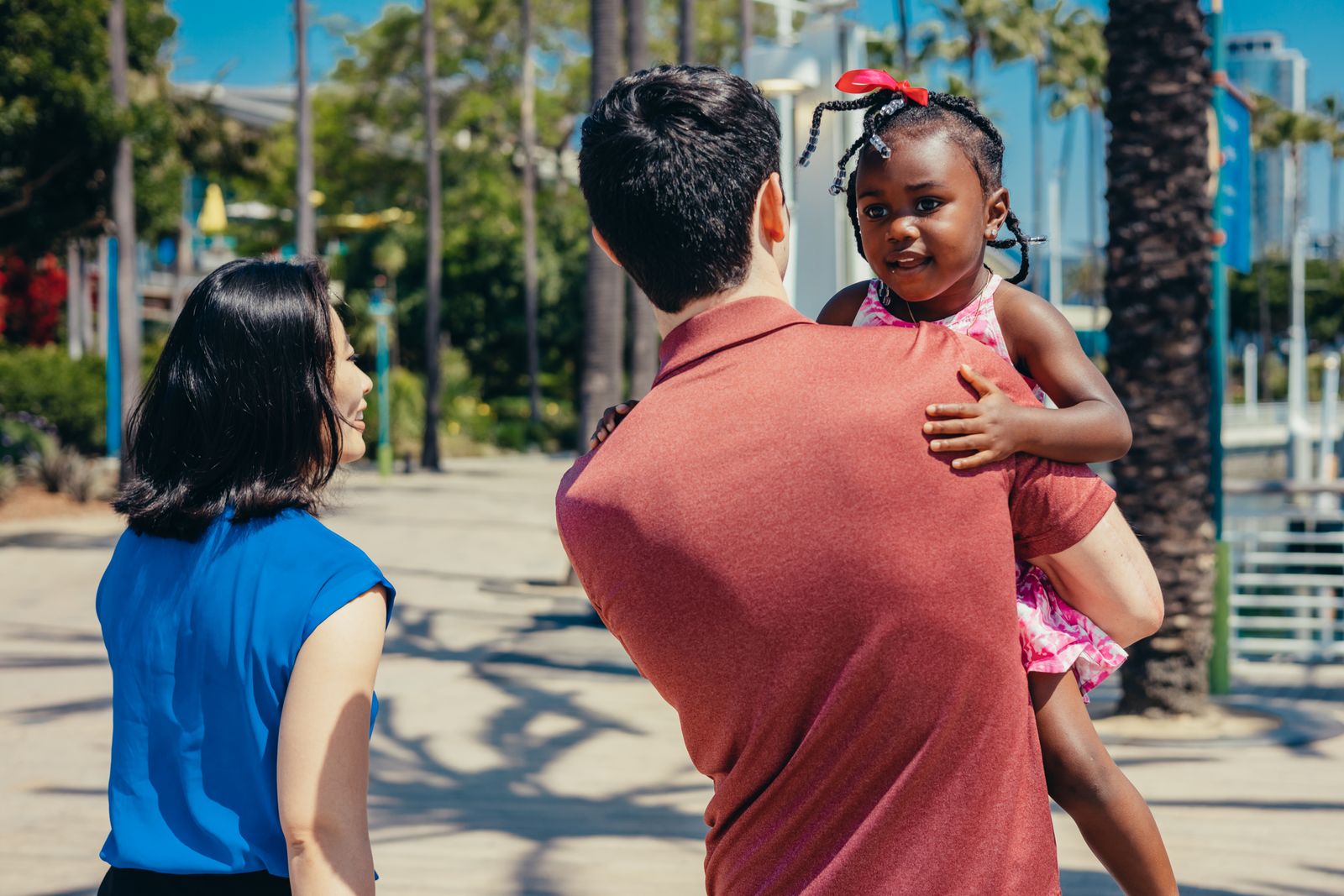 A joyful multicultural family enjoying a sunny day outdoors.